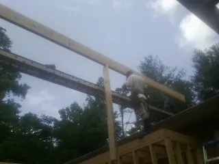 Carpenter setting a ridge beam over a new addition frame — Ice Dam Removal by Roofing Brothers in Orwigsburg