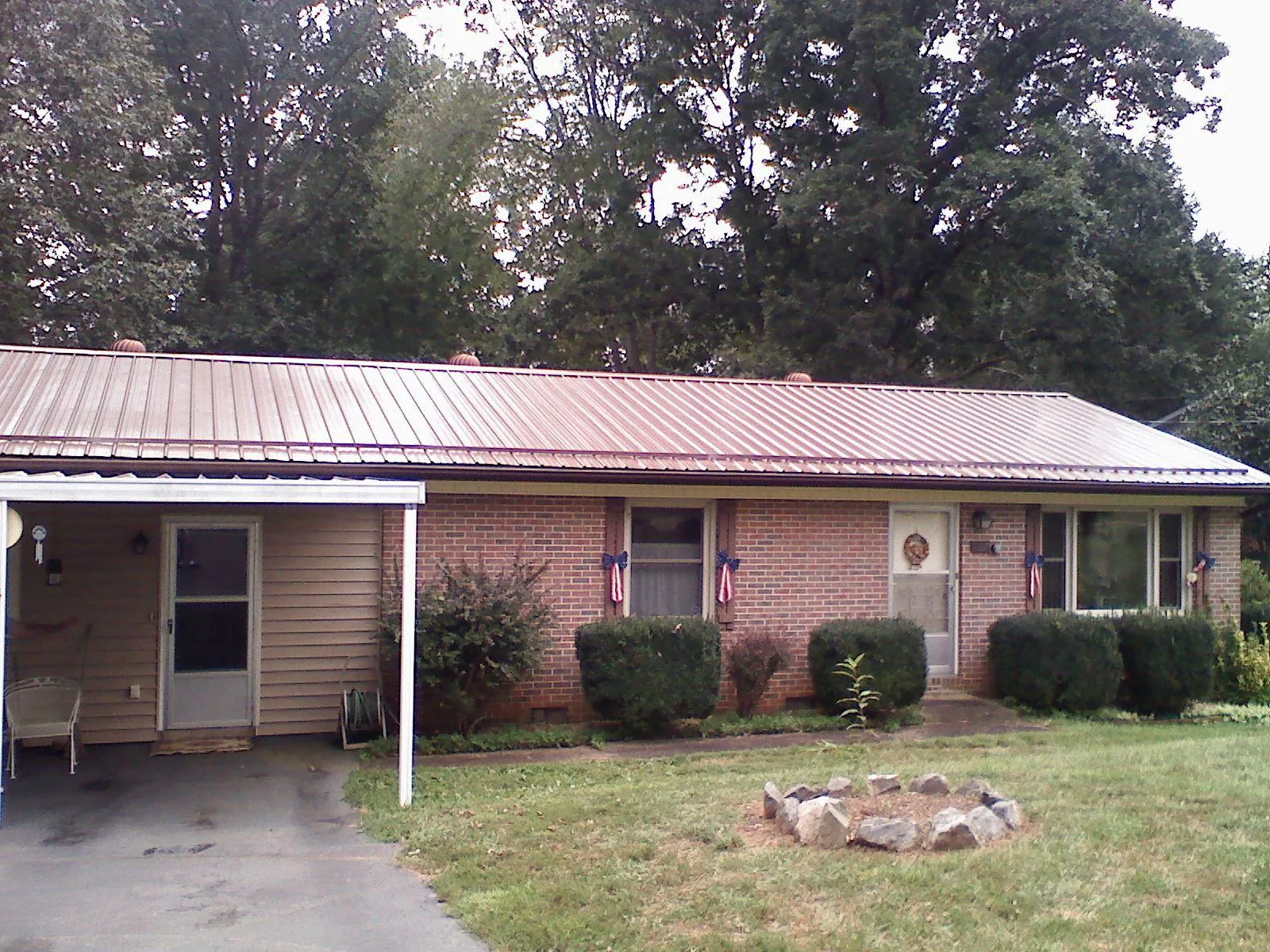 Bronze metal roof and carport on a brick ranch home — Roof Repair work by our crew in Orwigsburg